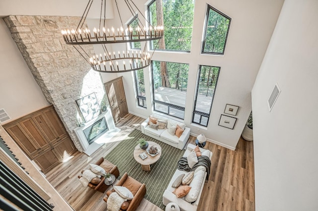 42732 Granite Cir, Shaver Lake, CA 93664 - living area with wood finished floors, a chandelier, and a towering ceiling
