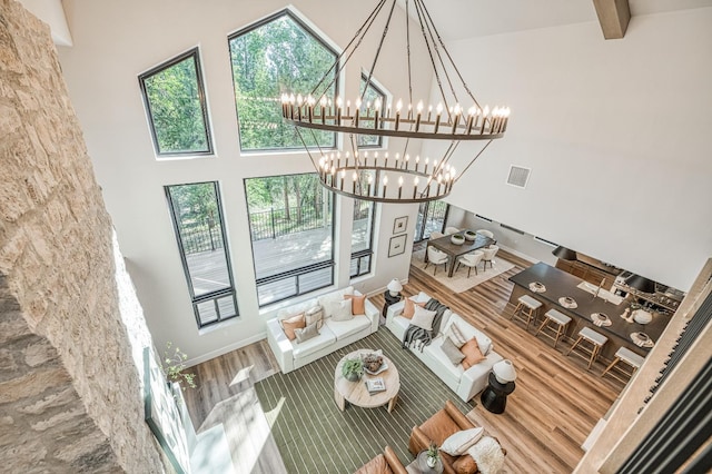 42732 Granite Cir, Shaver Lake, CA 93664 - living room with a chandelier, wood finished floors, and a towering ceiling