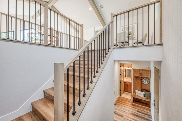 42732 Granite Cir, Shaver Lake, CA 93664 - stairway with a high ceiling, wood finished floors, and a textured wall