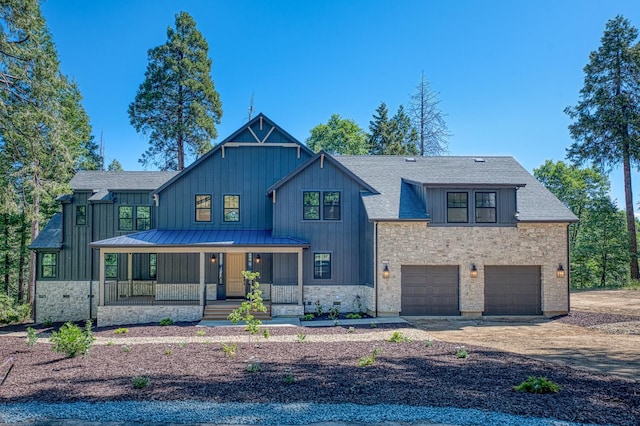 42732 Granite Cir, Shaver Lake, CA 93664 - modern farmhouse featuring covered porch, stone siding, a garage, a standing seam roof, and board and batten siding