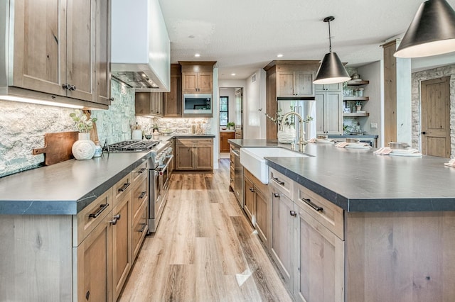 42732 Granite Cir, Shaver Lake, CA 93664 - kitchen with appliances with stainless steel finishes, custom range hood, light wood-type flooring, dark countertops, and recessed lighting