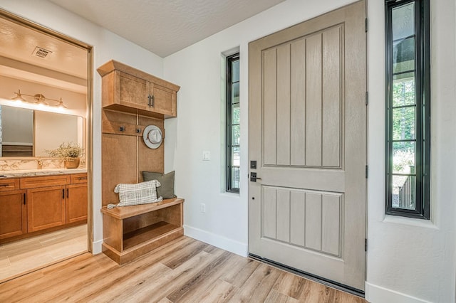 42732 Granite Cir, Shaver Lake, CA 93664 - foyer featuring light wood-type flooring and a textured ceiling