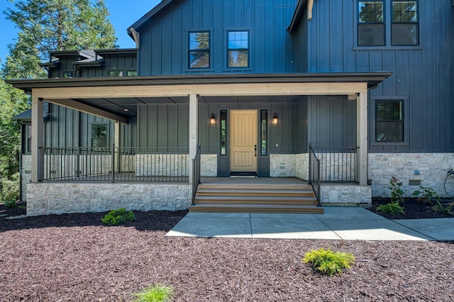 42732 Granite Cir, Shaver Lake, CA 93664 - modern farmhouse featuring board and batten siding, stone siding, and a porch