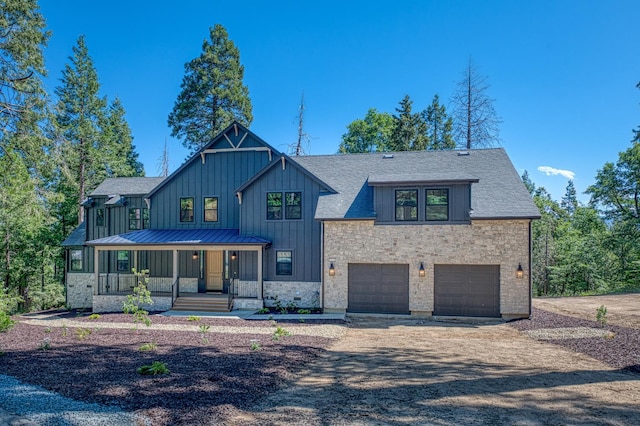 42732 Granite Cir, Shaver Lake, CA 93664 - modern inspired farmhouse featuring board and batten siding, concrete driveway, an attached garage, covered porch, and a shingled roof