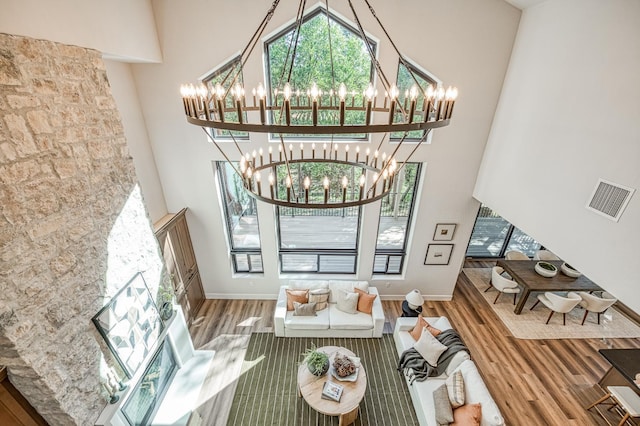 42732 Granite Cir, Shaver Lake, CA 93664 - living room featuring a towering ceiling, a chandelier, and wood finished floors