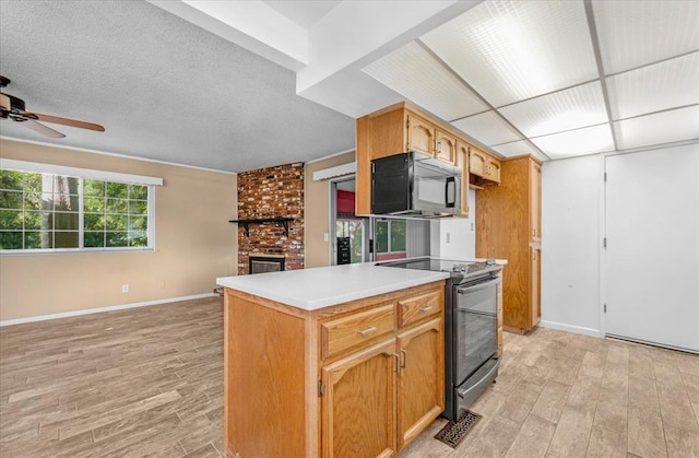 1649 W Menlo, Fresno, CA 93711 - kitchen with black microwave, electric stove, light wood finished floors, and open floor plan