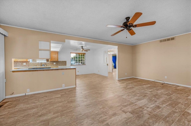 1649 W Menlo, Fresno, CA 93711 - unfurnished living room featuring a ceiling fan, a textured ceiling, light wood-style floors, and crown molding