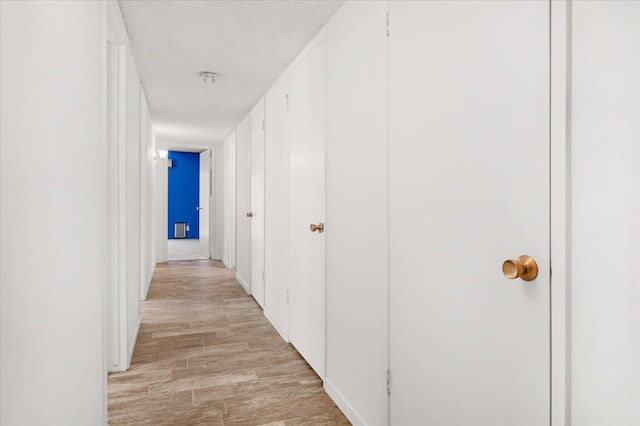 1649 W Menlo, Fresno, CA 93711 - hallway with light wood finished floors and a textured ceiling