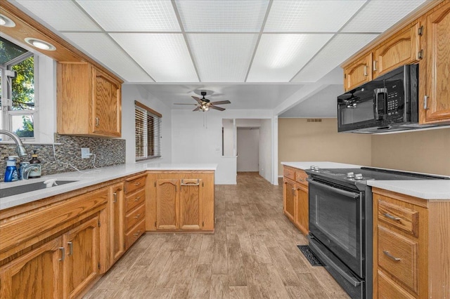 1649 W Menlo, Fresno, CA 93711 - kitchen with black appliances, a peninsula, light wood-style floors, light countertops, and tasteful backsplash