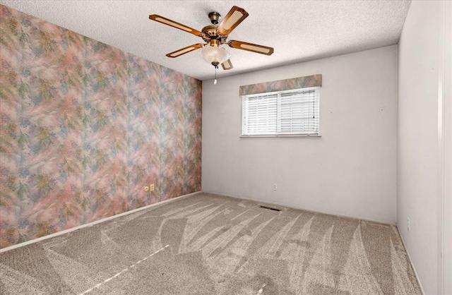 1649 W Menlo, Fresno, CA 93711 - empty room with carpet, a ceiling fan, a textured ceiling, and wallpapered walls