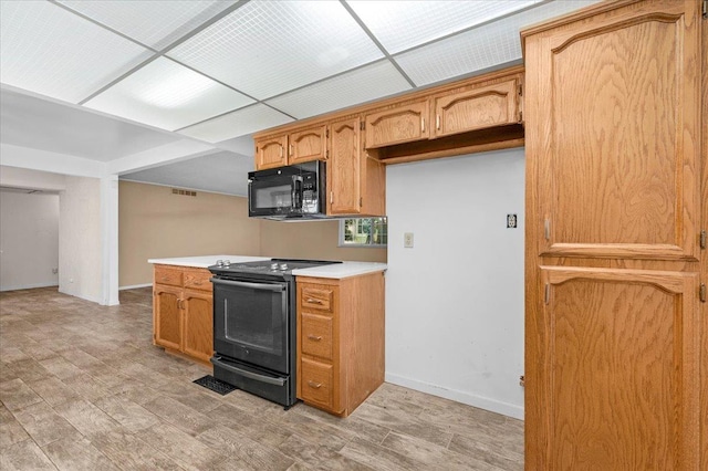 1649 W Menlo, Fresno, CA 93711 - kitchen with black appliances, light countertops, light wood-style floors, and brown cabinetry