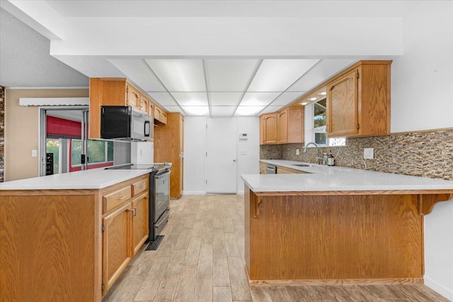 1649 W Menlo, Fresno, CA 93711 - kitchen featuring black appliances, a peninsula, light wood-style floors, and light countertops