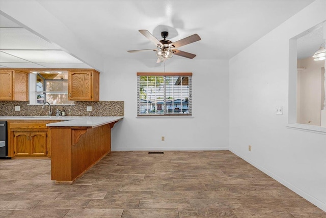 1649 W Menlo, Fresno, CA 93711 - kitchen with tasteful backsplash, a kitchen bar, a peninsula, ceiling fan, and light countertops