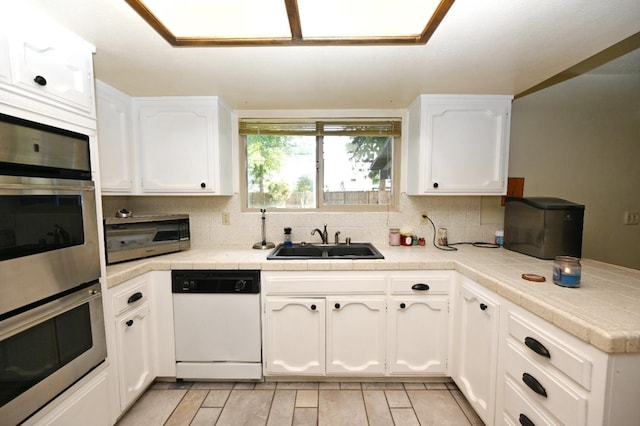 110 N Terry Ave, Clovis, CA 93612 - kitchen with appliances with stainless steel finishes, white cabinetry, backsplash, and light countertops