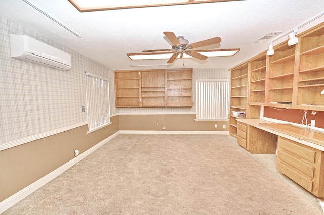 110 N Terry Ave, Clovis, CA 93612 - unfurnished office with a wall mounted air conditioner, built in desk, wallpapered walls, a ceiling fan, and a textured ceiling