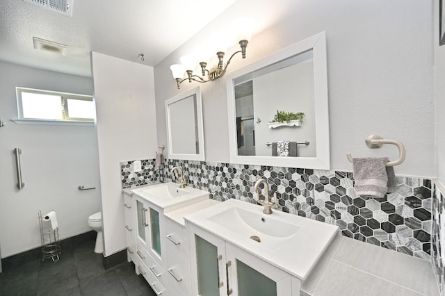 110 N Terry Ave, Clovis, CA 93612 - bathroom featuring two vanities, tasteful backsplash, and a shower with door