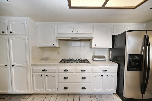 110 N Terry Ave, Clovis, CA 93612 - kitchen featuring appliances with stainless steel finishes, under cabinet range hood, white cabinetry, and light countertops