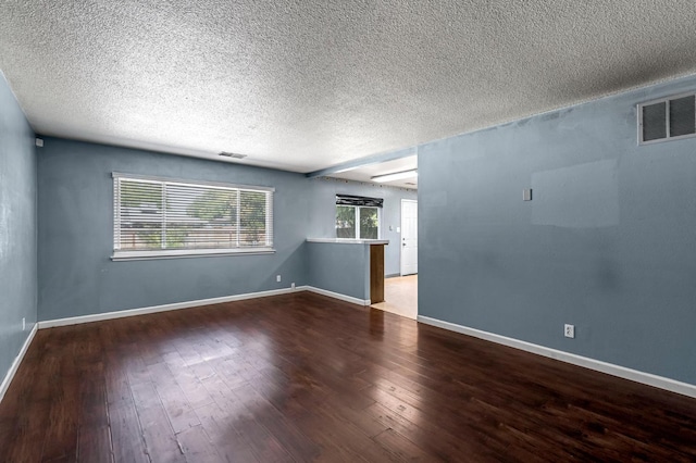 3635 N Hughes, Fresno, CA 93705 - empty room with a textured ceiling, plenty of natural light, and wood-type flooring