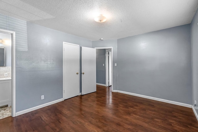 3635 N Hughes, Fresno, CA 93705 - unfurnished bedroom with wood finished floors, a textured ceiling, a closet, and ensuite bathroom