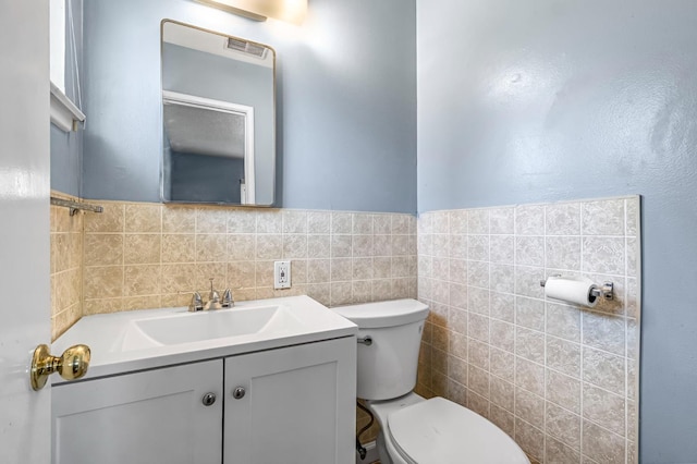 3635 N Hughes, Fresno, CA 93705 - bathroom featuring vanity, tile walls, and wainscoting
