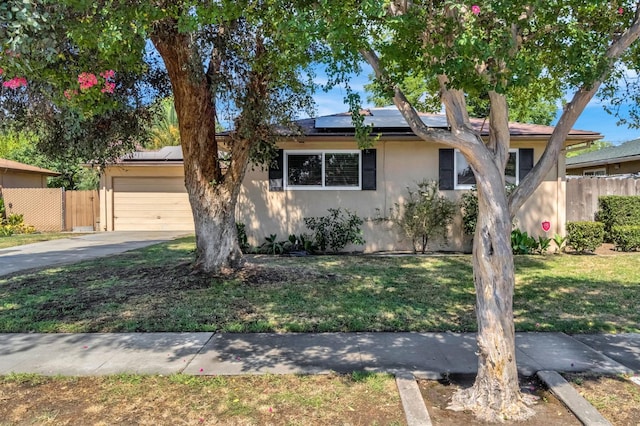 3635 N Hughes, Fresno, CA 93705 - single story home with stucco siding, roof mounted solar panels, concrete driveway, and an attached garage