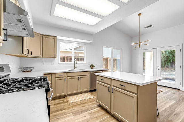 1033 Cypress Ct, Madera, CA 93637 - kitchen with stainless steel appliances, ventilation hood, light wood finished floors, and light countertops