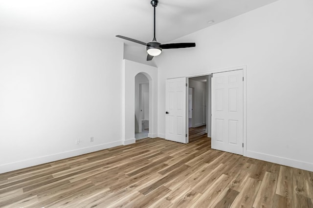 1033 Cypress Ct, Madera, CA 93637 - unfurnished bedroom with arched walkways, light wood-style floors, ceiling fan, and high vaulted ceiling