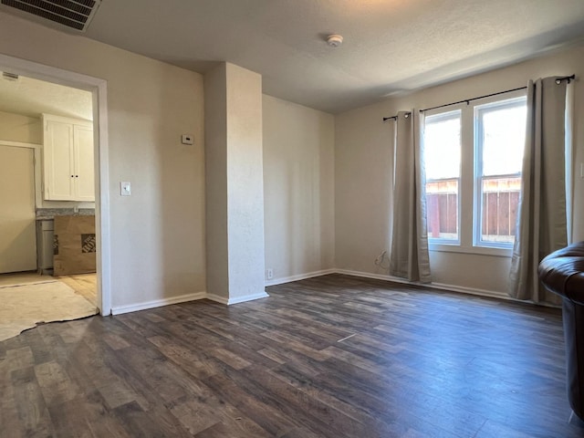 2405 E White Ave, Fresno, CA 93701 - empty room with dark wood finished floors and a smoke detector