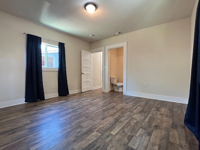2405 E White Ave, Fresno, CA 93701 - unfurnished bedroom featuring dark wood finished floors and ensuite bath