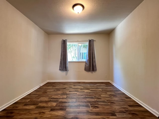 2405 E White Ave, Fresno, CA 93701 - empty room with dark wood-type flooring and a textured ceiling