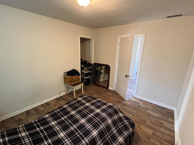 2405 E White Ave, Fresno, CA 93701 - bedroom with dark wood-style floors and baseboards