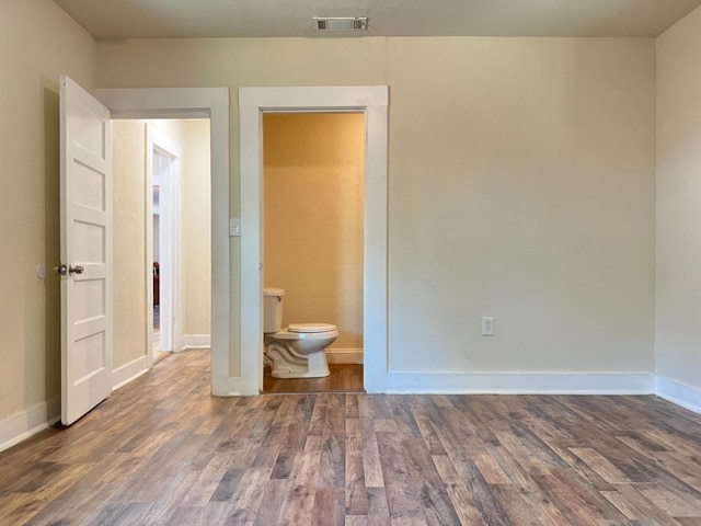 2405 E White Ave, Fresno, CA 93701 - unfurnished bedroom featuring wood finished floors and ensuite bath