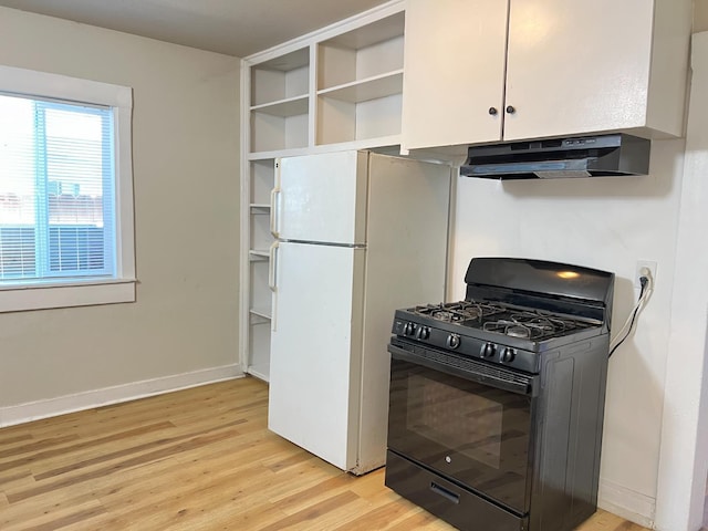 2405 E White Ave, Fresno, CA 93701 - kitchen featuring black range with gas stovetop, under cabinet range hood, light wood-type flooring, freestanding refrigerator, and open shelves