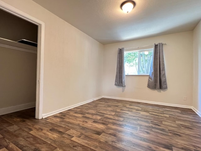 2405 E White Ave, Fresno, CA 93701 - unfurnished bedroom featuring dark wood-style flooring and baseboards