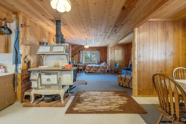 48675 Todd Eymann Rd, Miramonte, CA 93641 - bedroom with wooden ceiling, carpet flooring, wood walls, and a wood stove