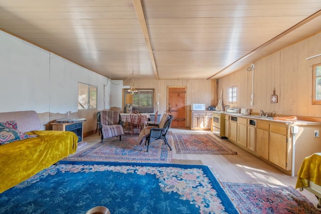 48675 Todd Eymann Rd, Miramonte, CA 93641 - living room with a chandelier, light wood-style floors, wood walls, and a wood ceiling with exposed beams