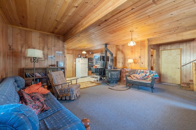 48675 Todd Eymann Rd, Miramonte, CA 93641 - living area featuring wooden walls, carpet, a wood stove, and wood ceiling