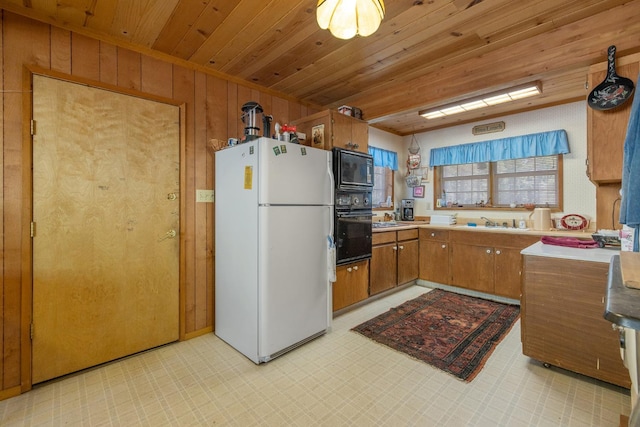 48675 Todd Eymann Rd, Miramonte, CA 93641 - kitchen featuring black appliances, brown cabinets, light flooring, wood ceiling, and wooden walls