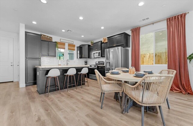 627 S Kandarian Ave, Fowler, CA 93625 - dining area with healthy amount of natural light, light wood-style flooring, and recessed lighting