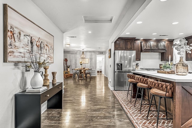 3377 N Bethel Ave, Sanger, CA 93657 - kitchen featuring stainless steel refrigerator with ice dispenser, a breakfast bar area, dark brown cabinetry, light countertops, and recessed lighting