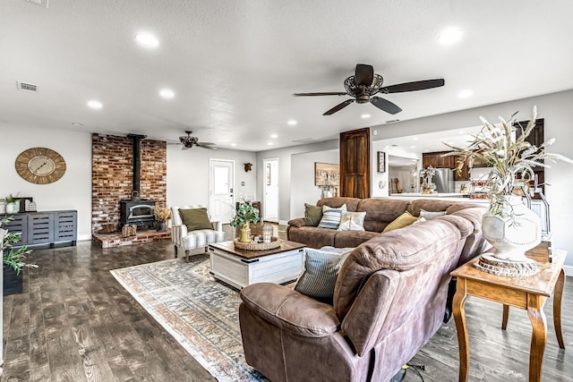 3377 N Bethel Ave, Sanger, CA 93657 - living room featuring ceiling fan, a wood stove, dark wood finished floors, and recessed lighting