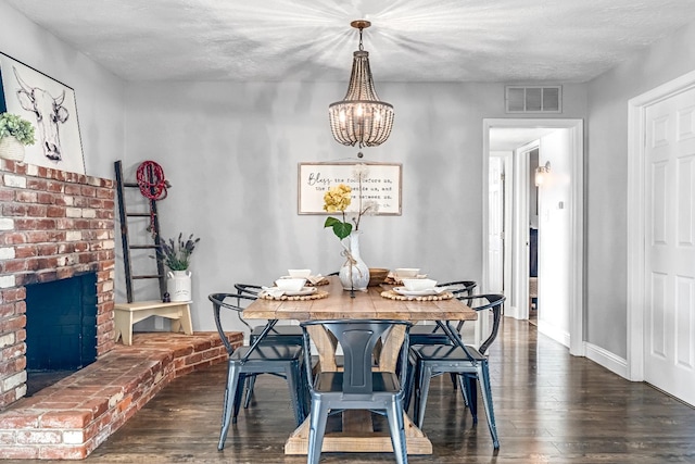 3377 N Bethel Ave, Sanger, CA 93657 - dining area with a chandelier, dark wood-style flooring, a textured ceiling, and a fireplace