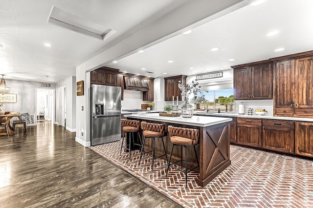 3377 N Bethel Ave, Sanger, CA 93657 - kitchen featuring stainless steel fridge, light countertops, a center island, a breakfast bar, and recessed lighting