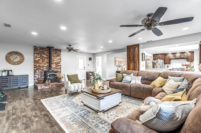 3377 N Bethel Ave, Sanger, CA 93657 - living room with ceiling fan, recessed lighting, a wood stove, and wood finished floors