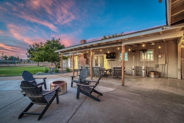 3377 N Bethel Ave, Sanger, CA 93657 - patio terrace at dusk featuring an outdoor fire pit, a patio, and french doors