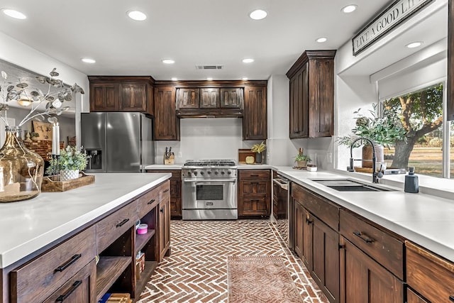 3377 N Bethel Ave, Sanger, CA 93657 - kitchen with appliances with stainless steel finishes, brick patterned flooring, light countertops, recessed lighting, and dark brown cabinetry