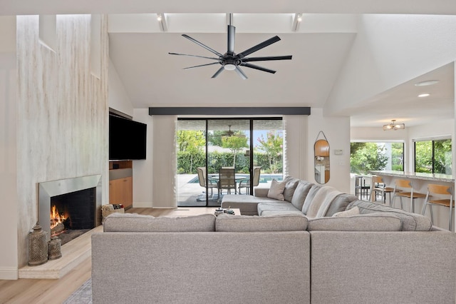 2734 W Bluff Ave, Fresno, CA 93711 - living area featuring wood finished floors, a large fireplace, healthy amount of natural light, and high vaulted ceiling