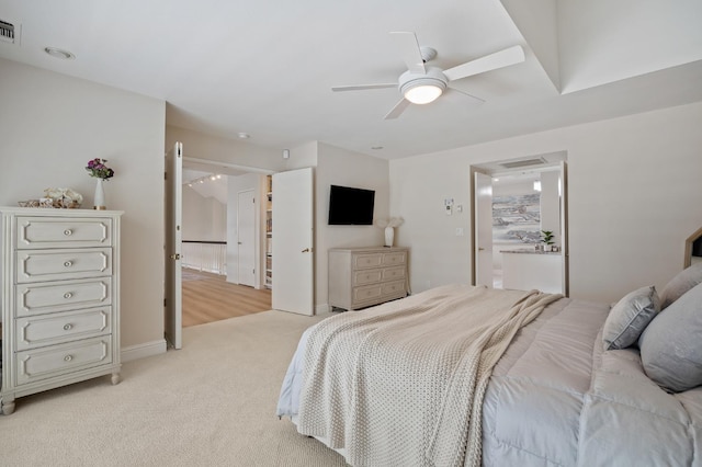 2734 W Bluff Ave, Fresno, CA 93711 - bedroom with light colored carpet, ceiling fan, and ensuite bath