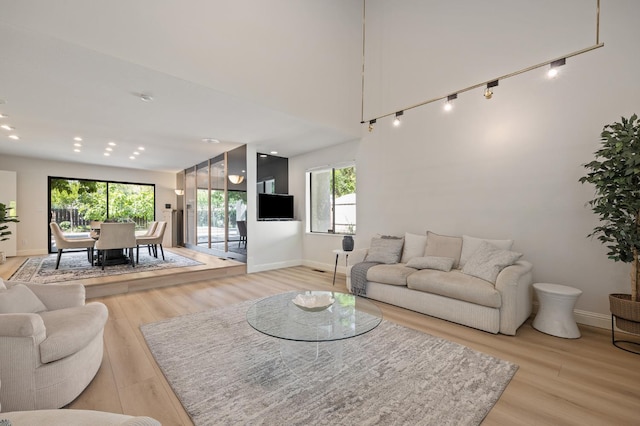2734 W Bluff Ave, Fresno, CA 93711 - living room featuring light wood finished floors and healthy amount of natural light