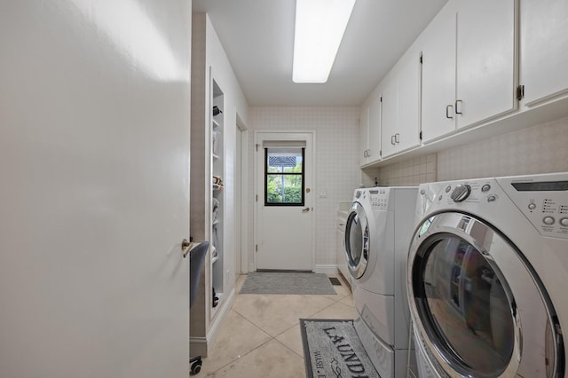 2734 W Bluff Ave, Fresno, CA 93711 - washroom featuring cabinet space, separate washer and dryer, light tile patterned flooring, and wallpapered walls